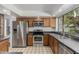 This kitchen has stainless steel appliances, wooden cabinets, recessed lights, and a large window at 9203 S Heather Dr, Tempe, AZ 85284
