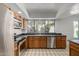 This kitchen has stainless steel appliances, wooden cabinets, recessed lights, and a large window at 9203 S Heather Dr, Tempe, AZ 85284