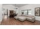 Bright living room with wood floors, a large sectional, and views of the pool through a window at 9203 S Heather Dr, Tempe, AZ 85284