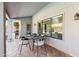 A covered patio with gray outdoor tile and wrought iron table and chairs at 9203 S Heather Dr, Tempe, AZ 85284
