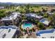 Aerial view of the community pool, cabana and verdant common areas amidst residential buildings at 9451 E Becker Ln # 2016, Scottsdale, AZ 85260