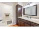 Bathroom with a granite countertop vanity, storage cabinet, and a shower/tub combo at 9451 E Becker Ln # 2016, Scottsdale, AZ 85260