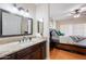 Bathroom with a granite countertop vanity, large mirror, and view of the bedroom at 9451 E Becker Ln # 2016, Scottsdale, AZ 85260