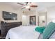 Spacious bedroom featuring a bed, dresser with TV, and access to the bathroom at 9451 E Becker Ln # 2016, Scottsdale, AZ 85260