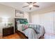 Comfortable bedroom with a queen-size bed, ceiling fan, and natural light from the sliding glass door at 9451 E Becker Ln # 2016, Scottsdale, AZ 85260