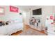 Teen bedroom with a bed, shelving unit, TV, and mirror at 9451 E Becker Ln # 2016, Scottsdale, AZ 85260