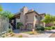 Well-maintained condo building exterior with a small palm tree and desert landscaping at 9451 E Becker Ln # 2016, Scottsdale, AZ 85260