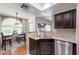 Open kitchen with stainless appliances, granite countertops, and adjacent dining area at 9451 E Becker Ln # 2016, Scottsdale, AZ 85260