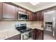 Kitchen boasts stainless steel appliances, granite countertops, and ample cabinet space at 9451 E Becker Ln # 2016, Scottsdale, AZ 85260