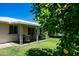 Lush backyard with a covered patio, citrus trees, and well-maintained lawn, ideal for relaxation at 9911 W Pleasant Valley Rd, Sun City, AZ 85351