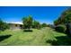 Lush backyard showcasing mature citrus trees, a well-maintained lawn, and privacy features at 9911 W Pleasant Valley Rd, Sun City, AZ 85351