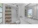 Well-lit bathroom featuring a shower-tub combo, marbled vanity, and mirrored cabinet at 9911 W Pleasant Valley Rd, Sun City, AZ 85351