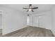 Clean bedroom offers wood-look flooring, ceiling fan, and double door closet at 9911 W Pleasant Valley Rd, Sun City, AZ 85351