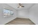 Bedroom featuring wood-look flooring, a ceiling fan, and a window at 9911 W Pleasant Valley Rd, Sun City, AZ 85351