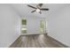 Spacious bedroom features wood-look floors and views of the lush backyard at 9911 W Pleasant Valley Rd, Sun City, AZ 85351