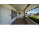 Inviting covered front porch with decorative security door and view of a well-maintained front yard at 9911 W Pleasant Valley Rd, Sun City, AZ 85351