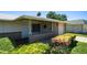 Charming front porch with brick accents, security door, and manicured landscaping, creating curb appeal at 9911 W Pleasant Valley Rd, Sun City, AZ 85351