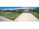 Charming single-story home featuring a manicured lawn, mature shrubs, and a spacious driveway at 9911 W Pleasant Valley Rd, Sun City, AZ 85351