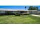 Charming single-story home with a well-maintained lawn and mature landscaping at 9911 W Pleasant Valley Rd, Sun City, AZ 85351