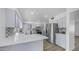 Renovated kitchen with stainless steel fridge, modern gray cabinetry, and sleek quartz countertops at 9911 W Pleasant Valley Rd, Sun City, AZ 85351