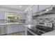 Updated kitchen with stainless steel appliances, stylish tile backsplash, and quartz countertops at 9911 W Pleasant Valley Rd, Sun City, AZ 85351