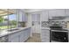 Bright kitchen with a large sink, window, stainless steel appliances, and modern countertops at 9911 W Pleasant Valley Rd, Sun City, AZ 85351