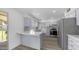 Open-concept kitchen boasts stainless appliances, quartz counters, and eat-in breakfast bar at 9911 W Pleasant Valley Rd, Sun City, AZ 85351