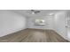 Spacious living area features neutral walls, wood-look floors, and ample natural light at 9911 W Pleasant Valley Rd, Sun City, AZ 85351