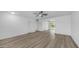 Bright, open living room boasts neutral paint, ceiling fan and wood-look flooring at 9911 W Pleasant Valley Rd, Sun City, AZ 85351