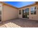 Backyard patio featuring a brick paver surface and sliding glass doors at 10311 E Trent Ave, Mesa, AZ 85212