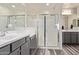 Bathroom featuring double sinks, modern shower, updated lighting and modern flooring at 10311 E Trent Ave, Mesa, AZ 85212