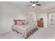 Comfortable bedroom featuring a decorative bed, a ceiling fan, and plenty of natural light at 10311 E Trent Ave, Mesa, AZ 85212