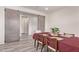 Dining room with a wooden table set for a meal, sliding barn doors, and modern flooring at 10311 E Trent Ave, Mesa, AZ 85212