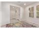 Spacious entryway with a stylish rug and shuttered windows creating a welcoming and well-lit first impression at 10311 E Trent Ave, Mesa, AZ 85212