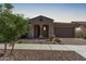 Charming single-story home with a tile roof, arched entryway, and two-car garage, nestled in a well-maintained neighborhood at 10311 E Trent Ave, Mesa, AZ 85212