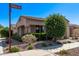 Attractive home with a tile roof, manicured landscaping, and stone accents, blending comfort with curb appeal at 10311 E Trent Ave, Mesa, AZ 85212