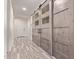 Bright hallway with decorative sliding barn doors and wood-look tile flooring offering style and functionality at 10311 E Trent Ave, Mesa, AZ 85212
