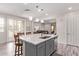 Modern kitchen island featuring quartz countertops, pendant lighting, and stainless steel appliances at 10311 E Trent Ave, Mesa, AZ 85212