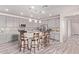 Modern kitchen with gray cabinets, a large island with seating, and stainless steel appliances offering style and functionality at 10311 E Trent Ave, Mesa, AZ 85212