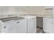 Bright laundry room with front load washer and dryer and granite countertop at 10311 E Trent Ave, Mesa, AZ 85212