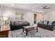 Comfortable living room with stylish sofas, patterned rug, and a ceiling fan for added comfort at 10311 E Trent Ave, Mesa, AZ 85212