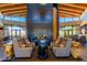 Lobby area with a fireplace and chairs for seating under a wood-beam ceiling at 10311 E Trent Ave, Mesa, AZ 85212