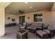 Covered patio with comfortable seating, ceiling fan, and a decorative fire pit at 10311 E Trent Ave, Mesa, AZ 85212