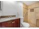 Bathroom with wood vanity, granite countertop, tiled shower, toilet, and modern fixtures at 1052 S San Jose St # 6, Mesa, AZ 85202