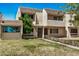 Exterior view of a two-story townhome featuring a stucco facade, brown roof, and a neatly manicured lawn at 1052 S San Jose St # 6, Mesa, AZ 85202