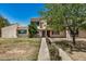 Inviting townhome featuring a well-maintained lawn, mature trees and a pathway leading to the front door at 1052 S San Jose St # 6, Mesa, AZ 85202