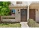 Close up of the front entry of a townhome featuring a secure metal door and well-maintained landscaping at 1052 S San Jose St # 6, Mesa, AZ 85202