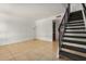 Open living space with neutral walls, tiled flooring, staircase and a modern lamp at 1052 S San Jose St # 6, Mesa, AZ 85202