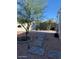 Desert landscaped backyard featuring gravel, pavers, mature tree, and block fence at 111 S Greenfield Rd # 785, Mesa, AZ 85206