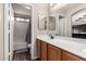 Bathroom with wood cabinets, a well-lit vanity, and a shower-tub combination for relaxation at 13159 W Caribbean Ln, Surprise, AZ 85379